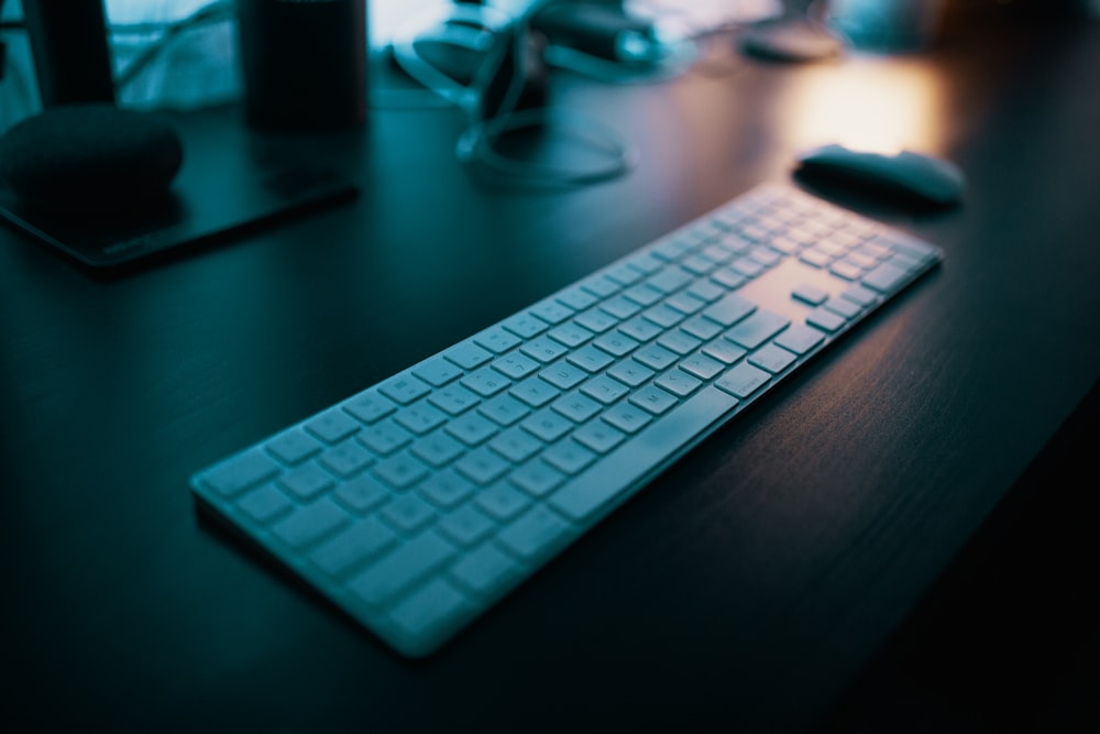 Apple keyboard next to mouse