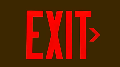 Fire extinguisher and emergency exit signs clearly displayed in a workplace.