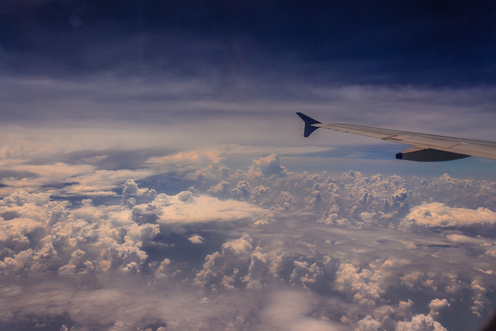 white and black plane wing on sky