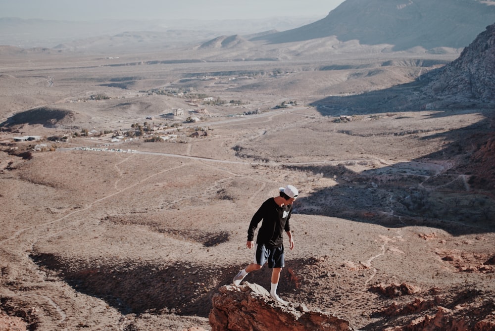 man walking on rock during daytime