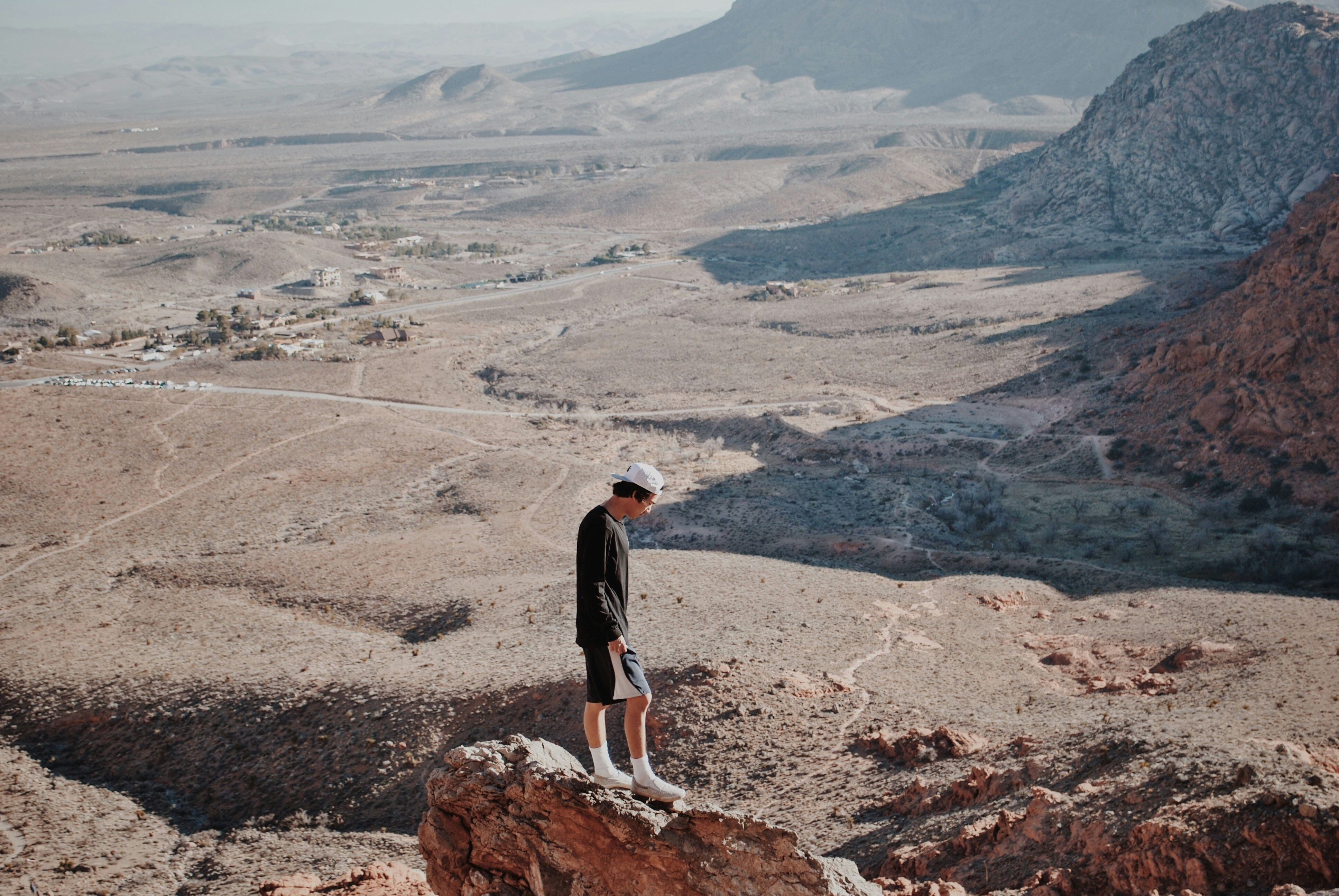 man in black shirt stands on mountain