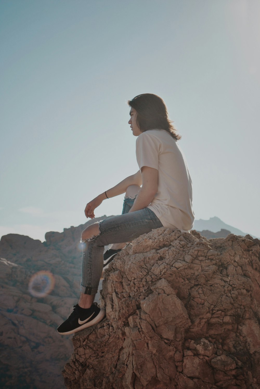 man sitting on rock