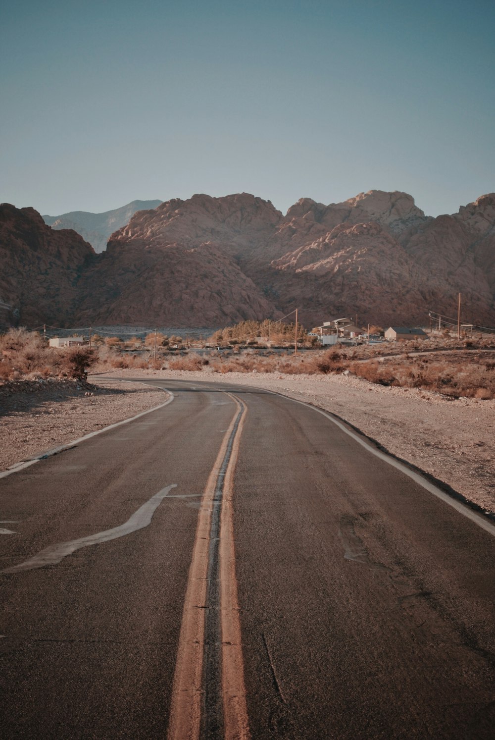 gray top road with two yellow lines on midle