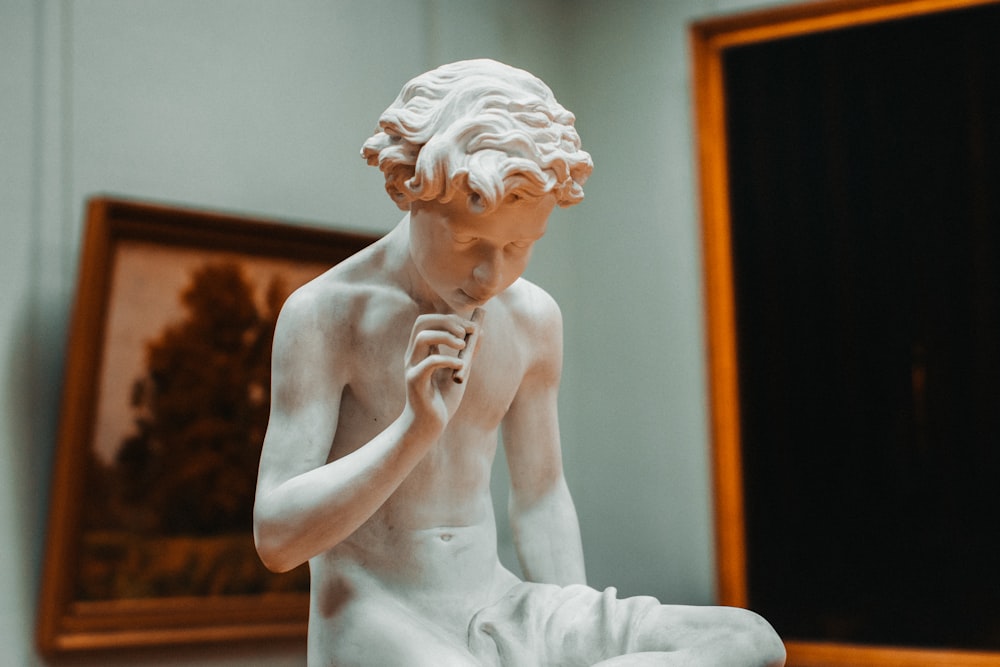 naked man smoking figurine