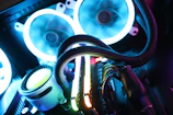 Close-up of a glowing home lab rack with neon-lit cables and hardware.