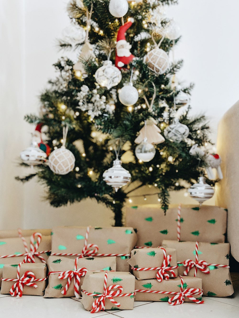 bundle of gifts near Christmas tree