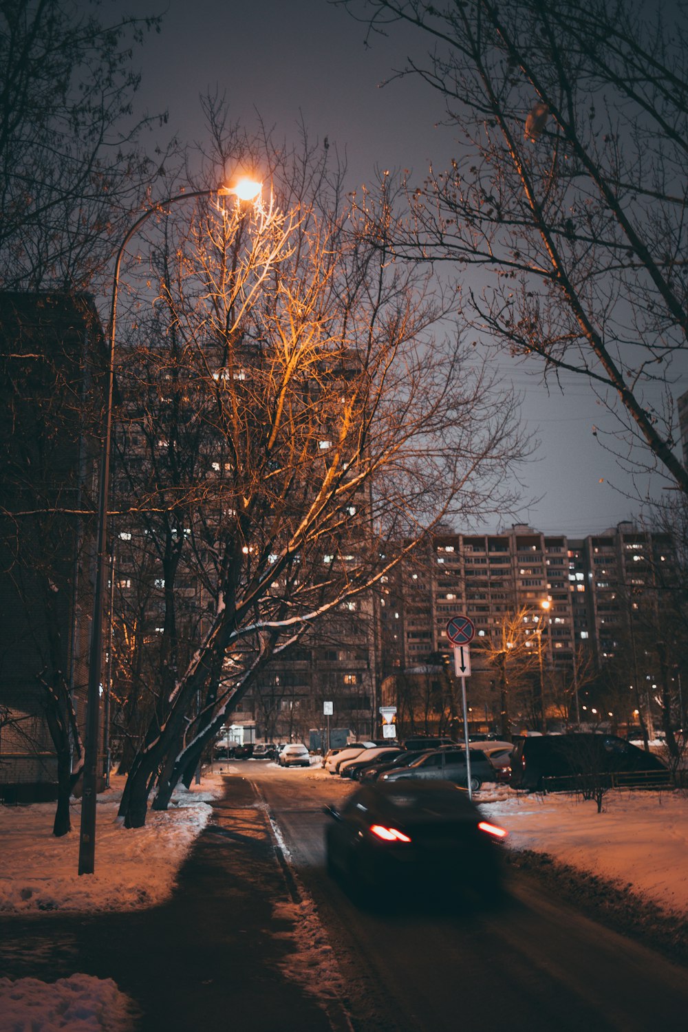 black sedan passing through road