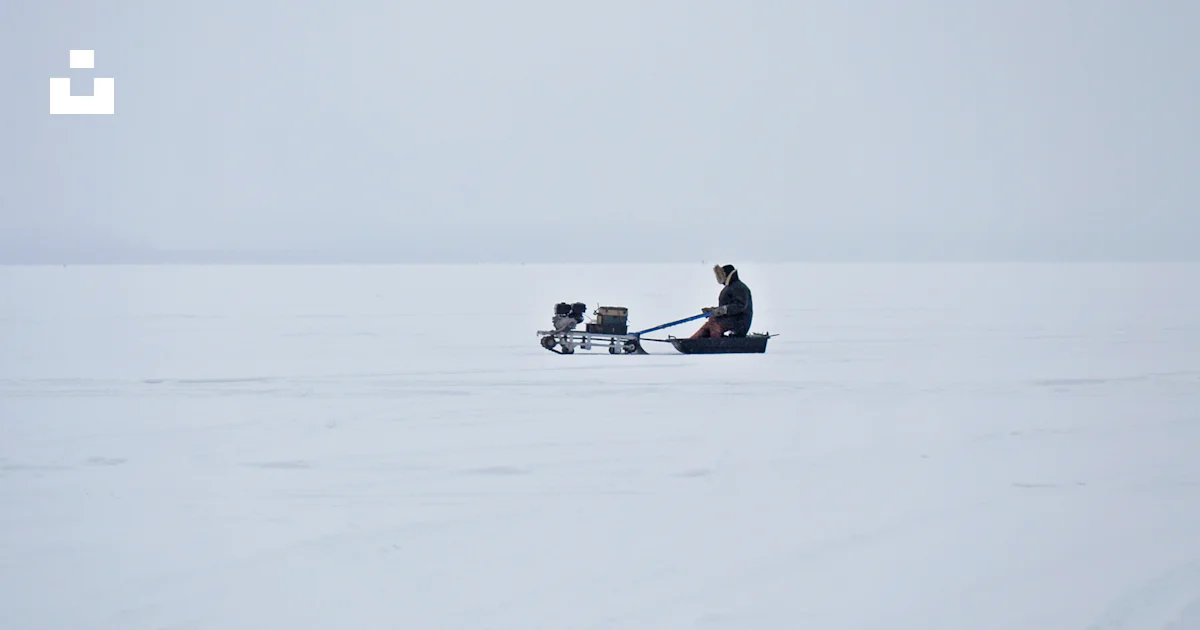 Man Riding Sled Man riding pulled sled in the middle of snowy field photo – Free Winter ...
