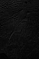a black and white photo of water and sand