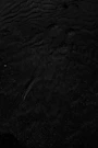 a black and white photo of water and sand