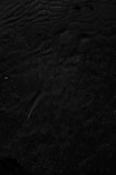 a black and white photo of water and sand