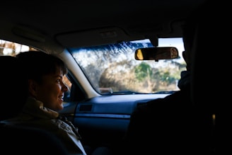 A friendly driver greeting a smiling passenger outside a local Hudson Valley landmark