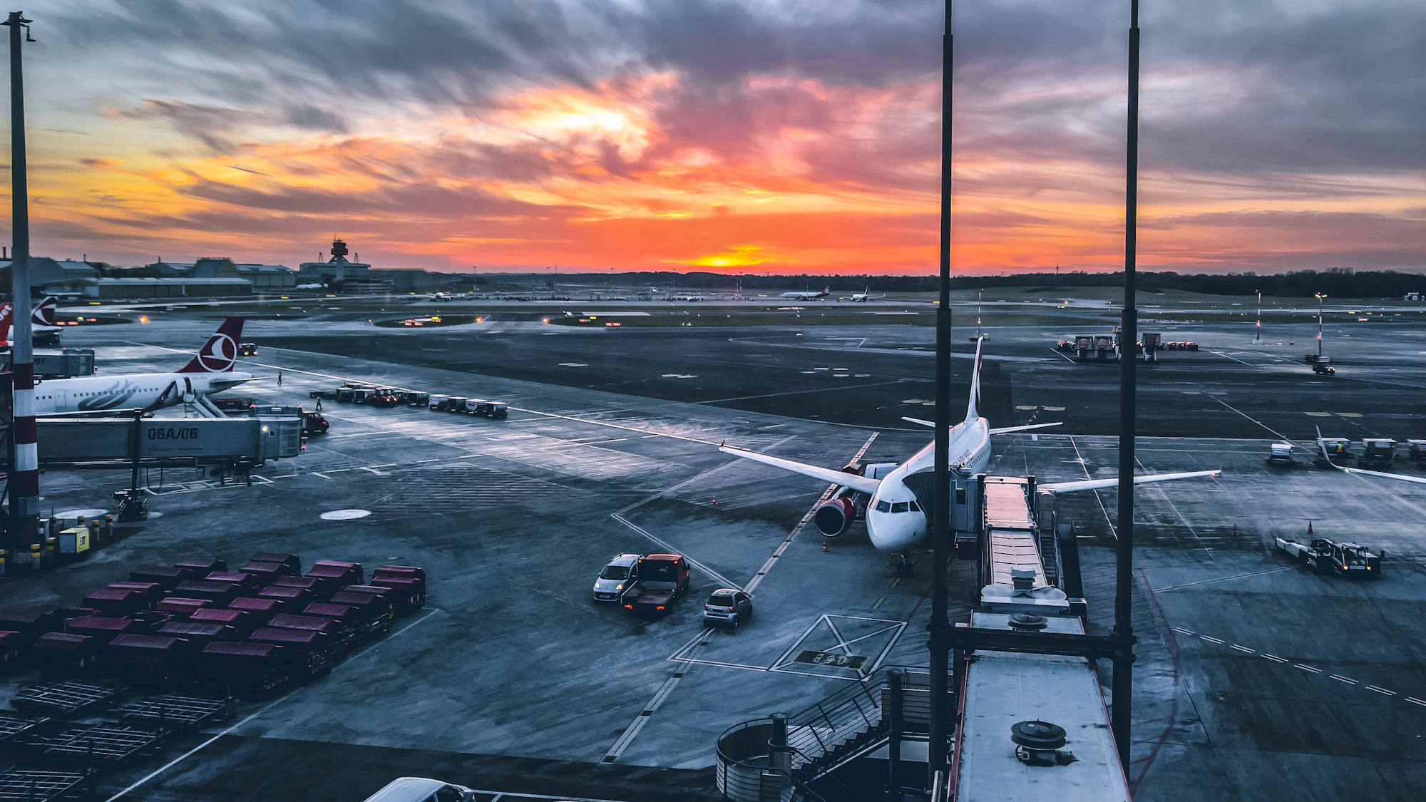 Airplane at the airport terminal during a golden sunset