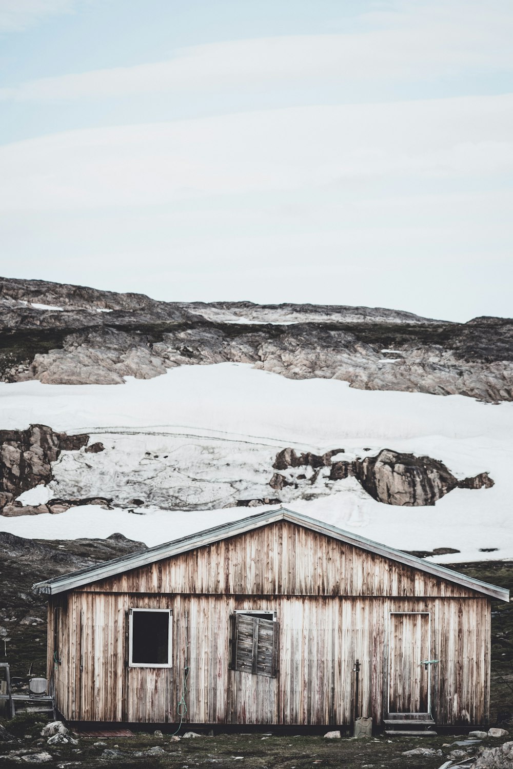 brown house front of snow field