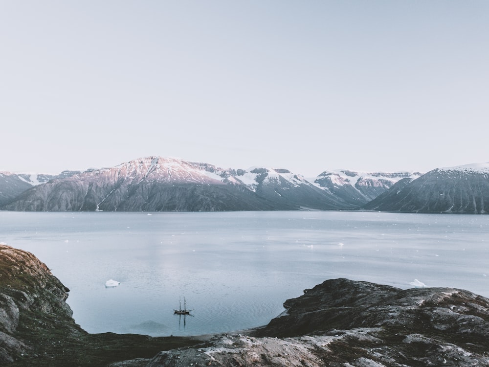 snow covered mountain and lake