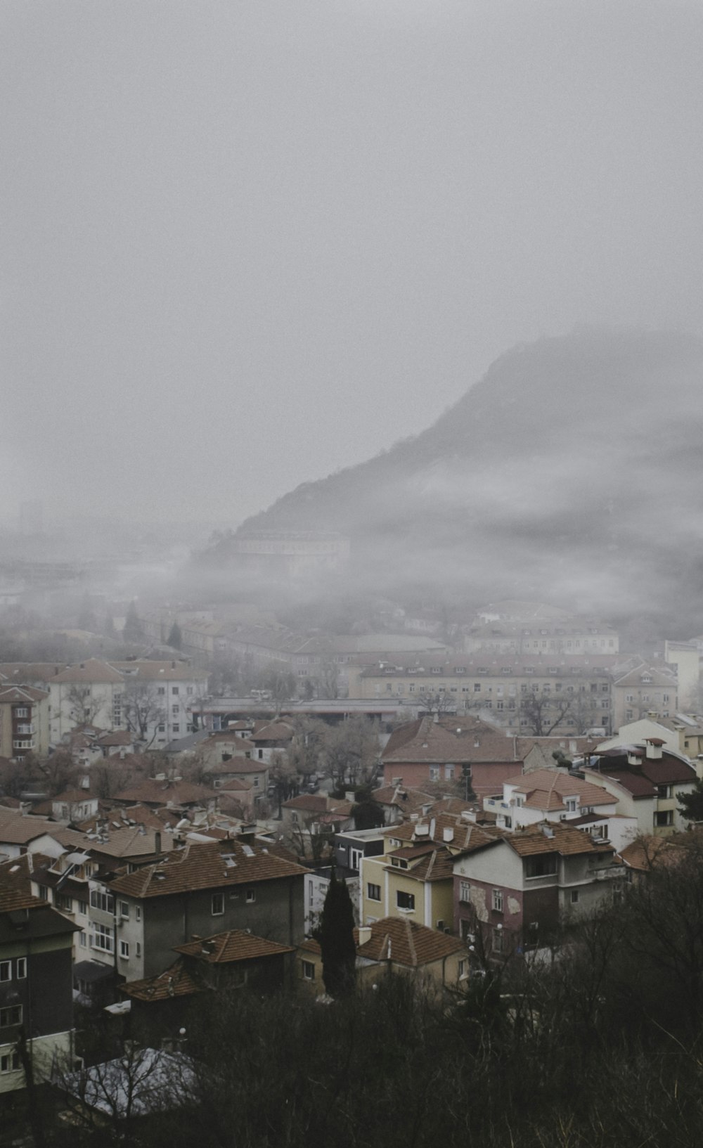 houses beside mountain at daytime