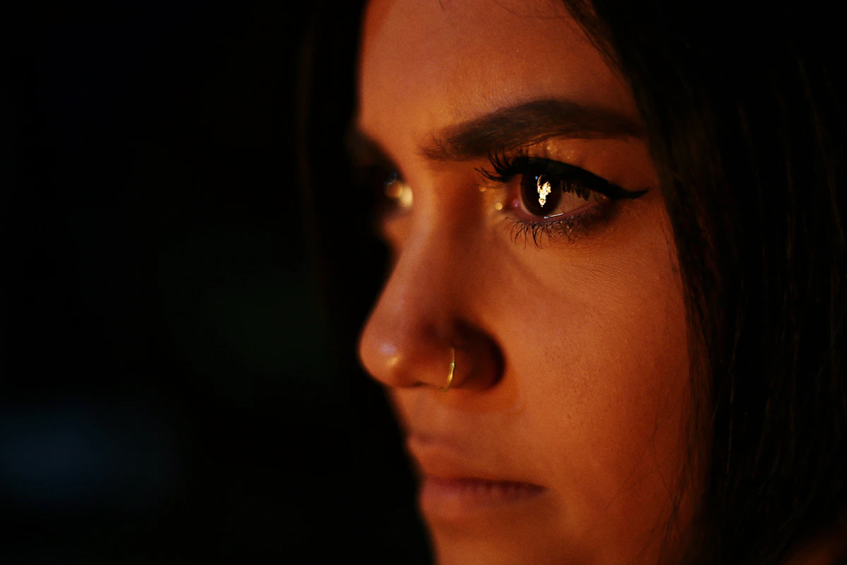 Woman with a nose piercing in soft light