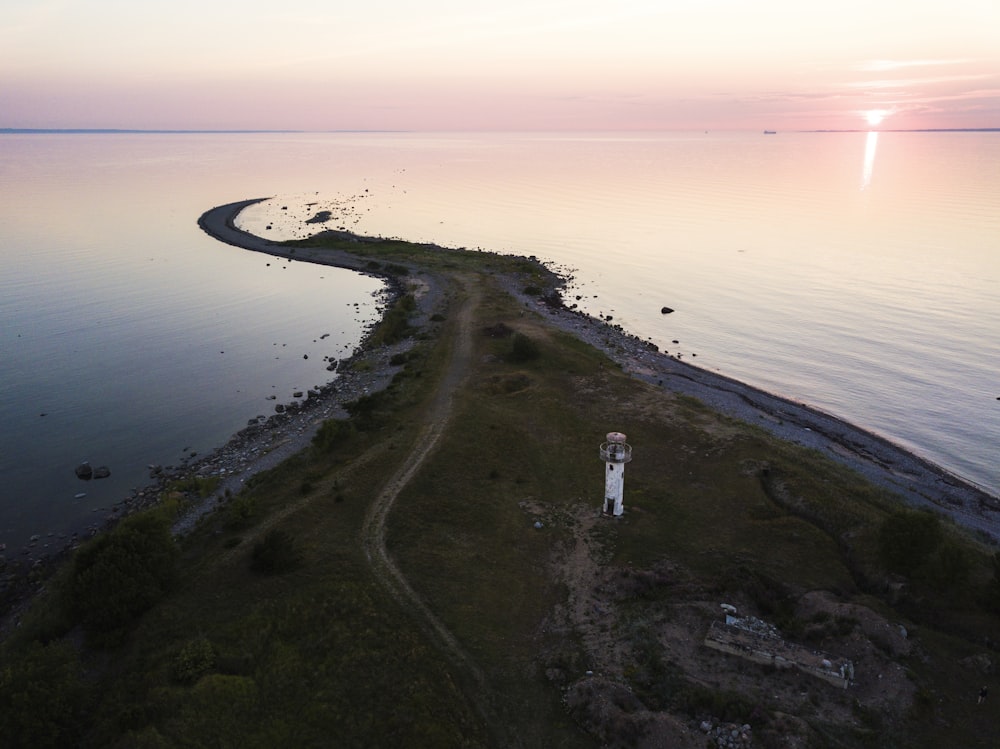 lighthouse near the ocean during day