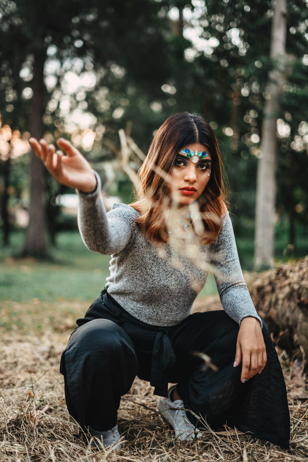 selective focus photography of woman throwing grass