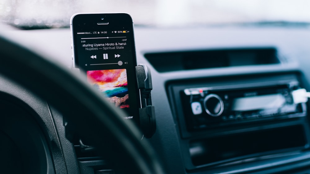 black iPhone on black car smartphone holder