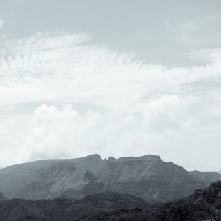 A serene landscape with soft clouds and gentle hills, evoking a sense of calm and tranquility.