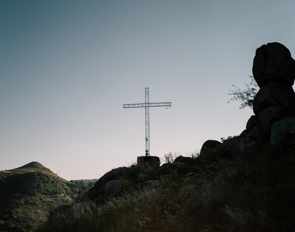 gray cross on peak at daytime