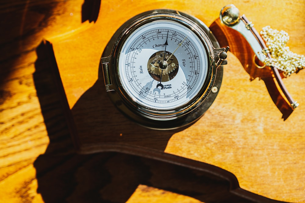 round silver-colored compass