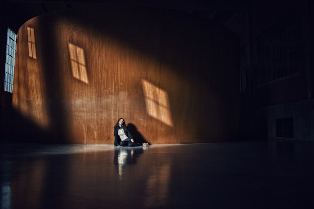 woman lying on floor with sunlight passing through glass window