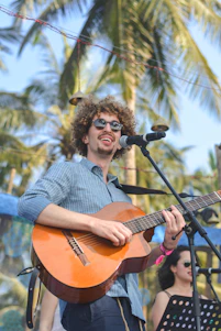 selective focus photography of man performing on stage playing guitar