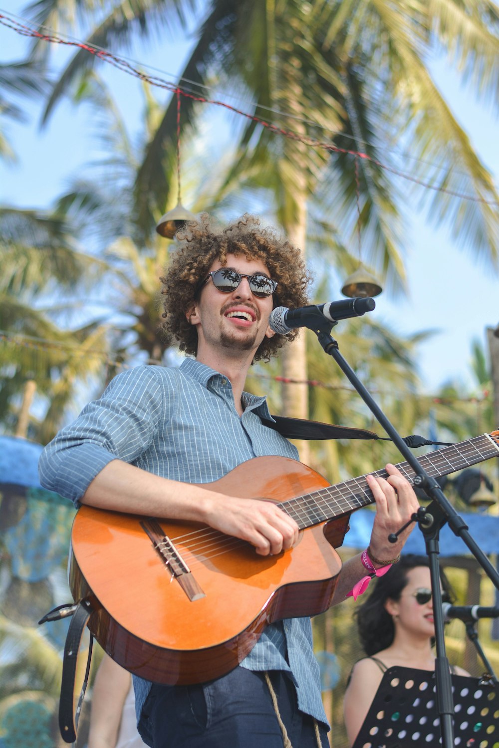 selective focus photography of man performing on stage playing guitar