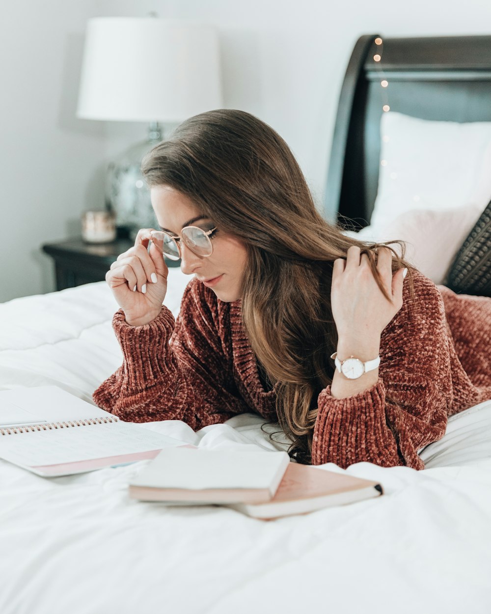 woman reading notes on bed