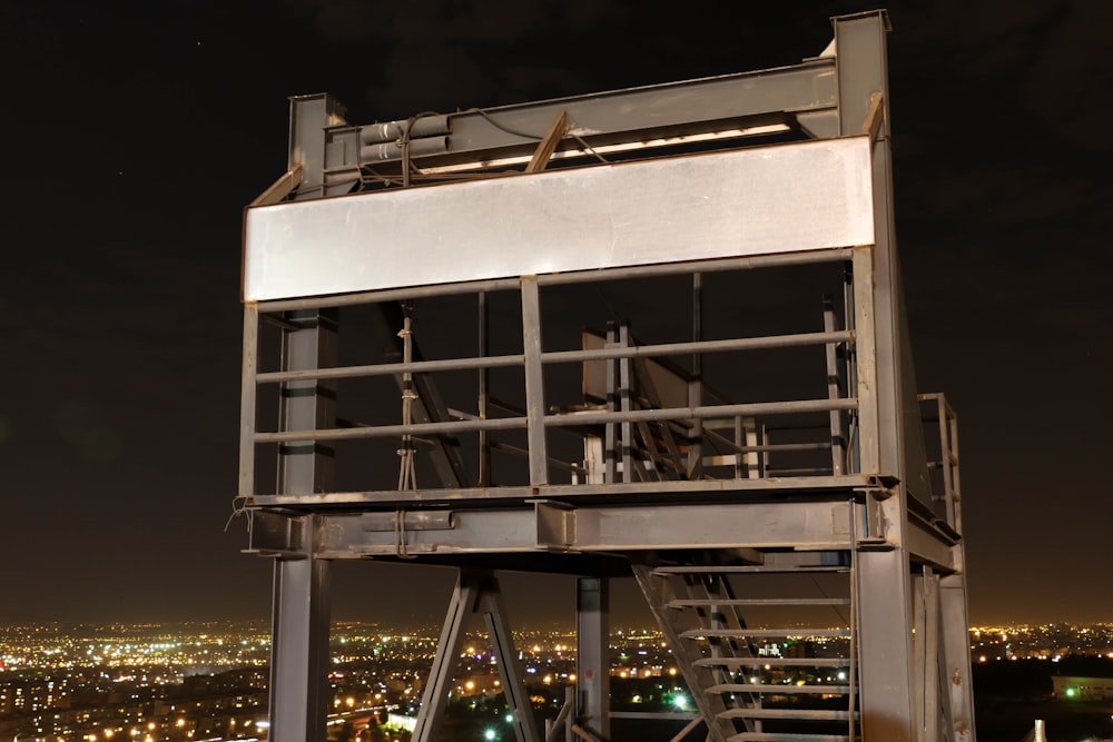 gray metal building overlooking city lights