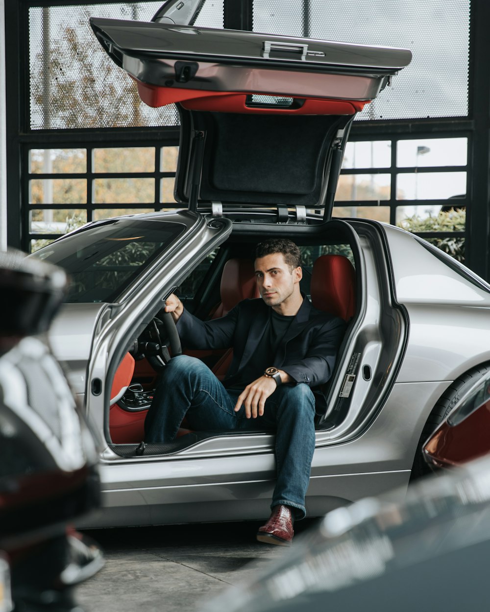 man sitting on sports car