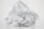 Crumbled foil loosely wrapped in a plastic sheet on a plain background. The plastic is transparent and the foil is shiny with a metallic luster.