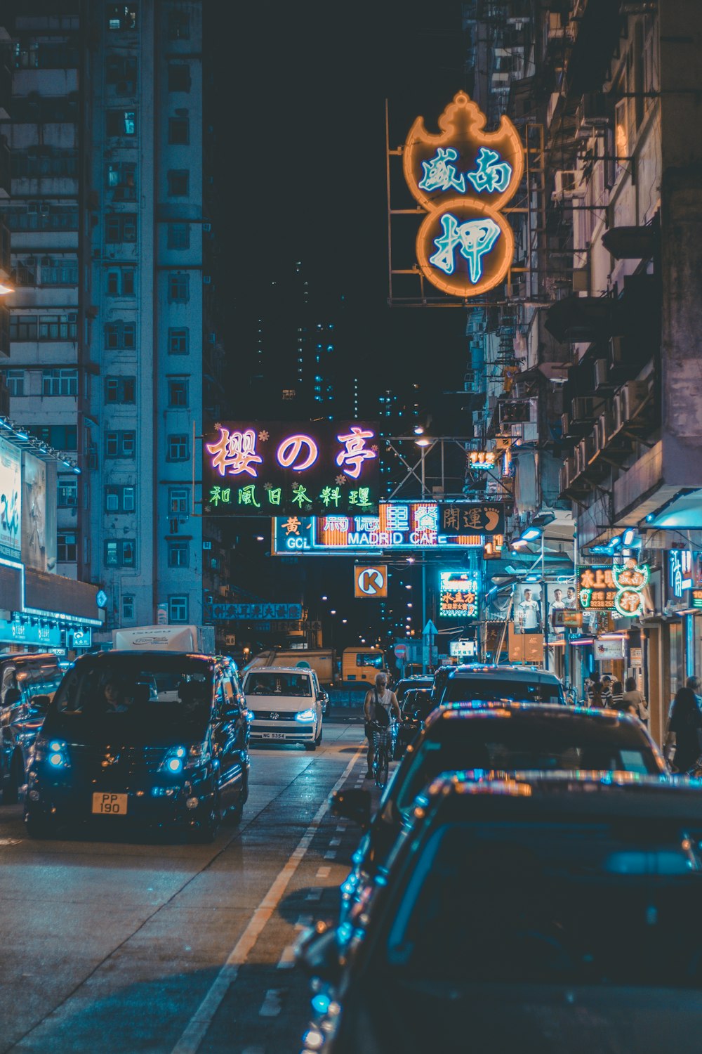 cars on road surrounded by building during night time