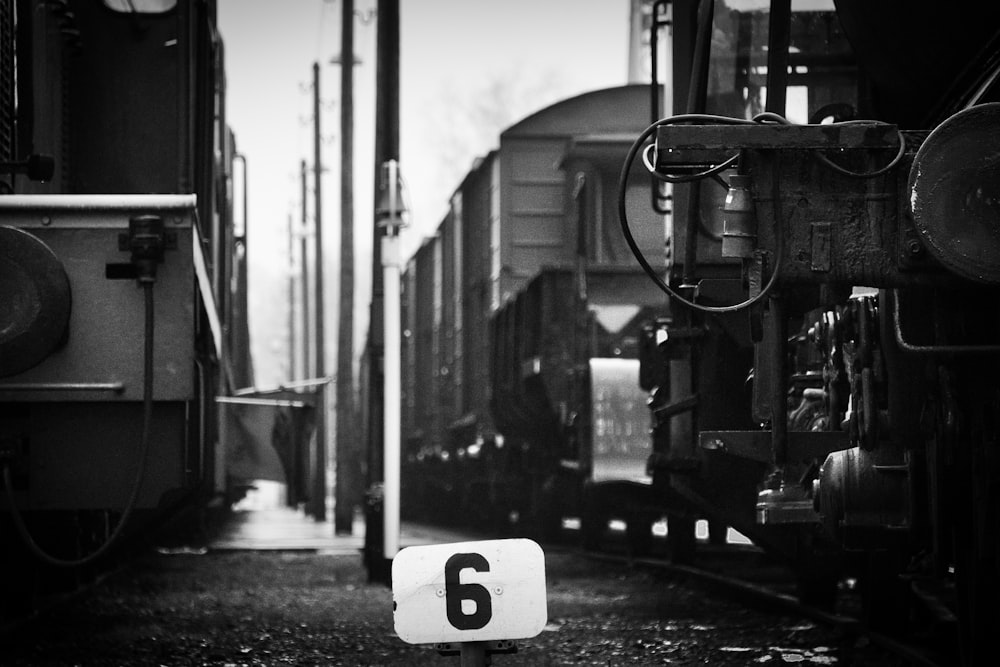 grayscale photography of trains on track