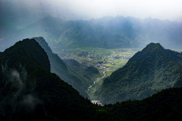 A serene view of Shivalik Valley with cozy resort cottages nestled among lush greenery.