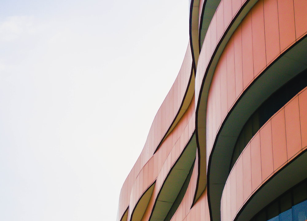 low-angle photography of red concrete multi-story building during daytime