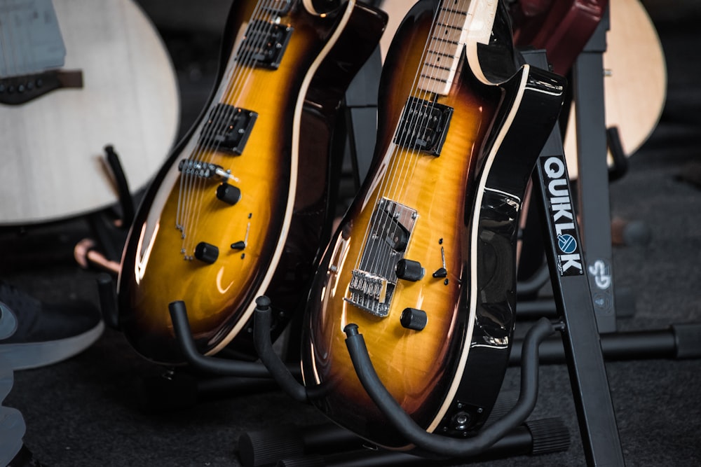 two brown-and-black guitars