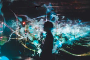 silhouette of person on blue digital wallpaper