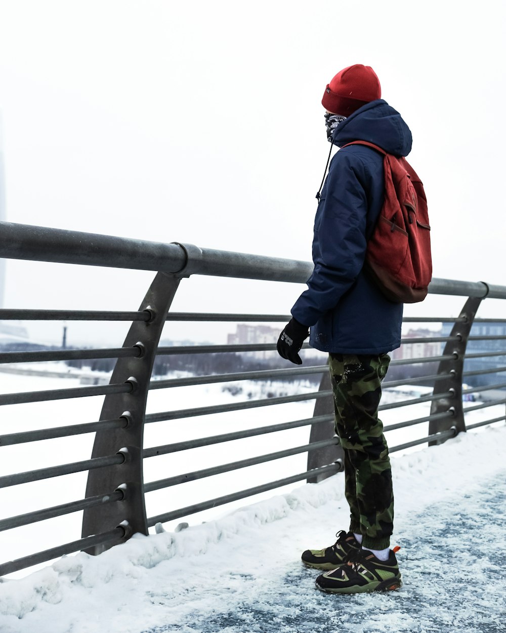 man standing near railing during daytime