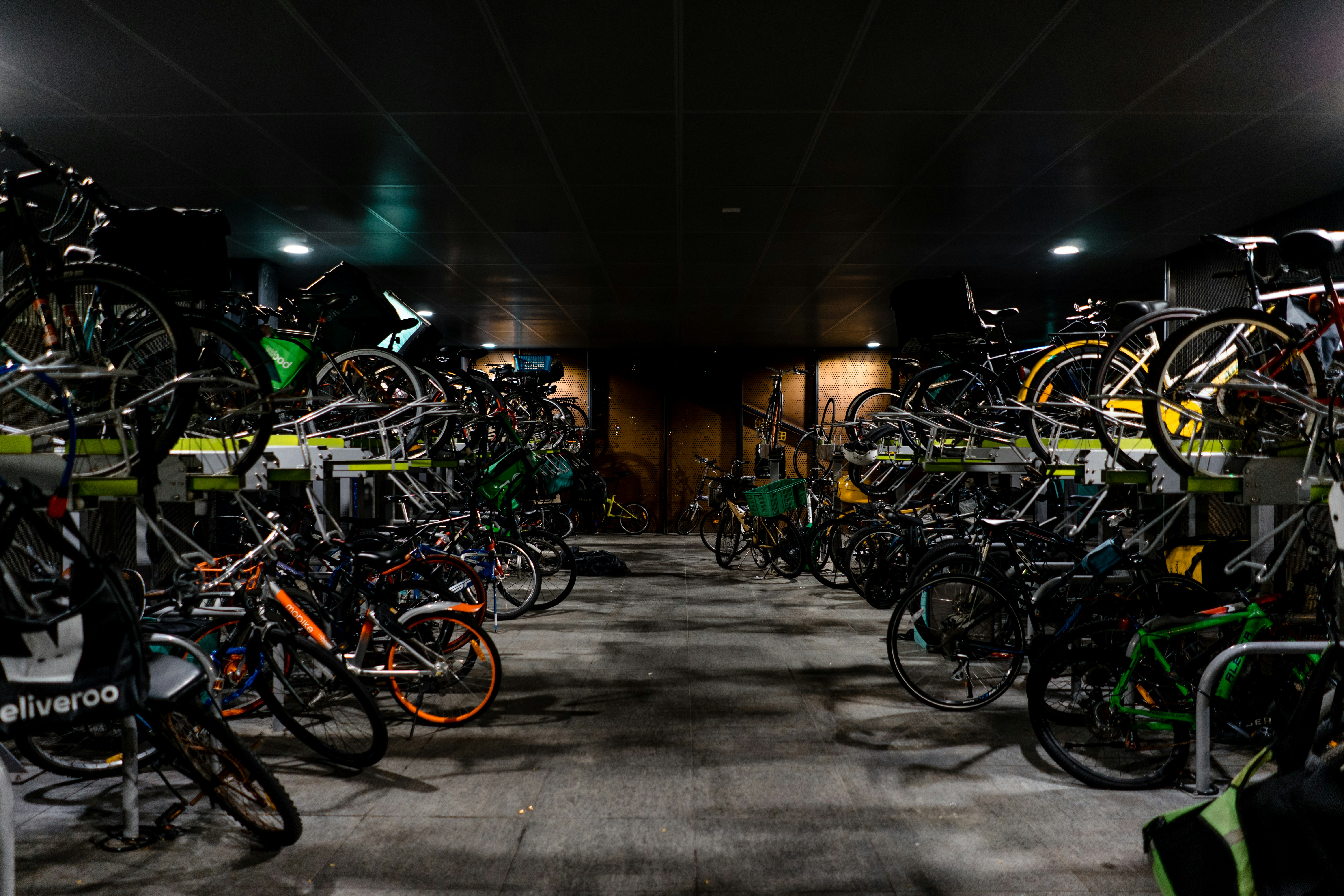 assorted-color bicycles, Riders - those for leisure, for work, and for deliveries, all park their bicycles in a parking area.