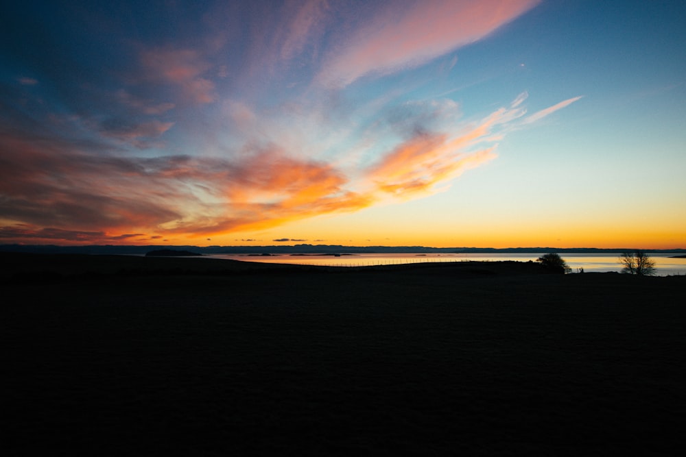 silhouette photography of calm water