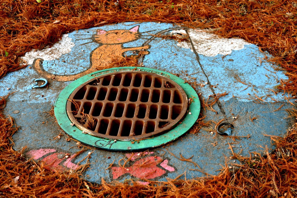 round brown and green manhole
