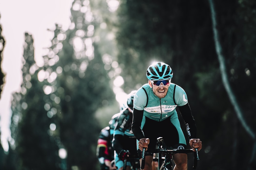 shallow focus of man riding bike during daytime