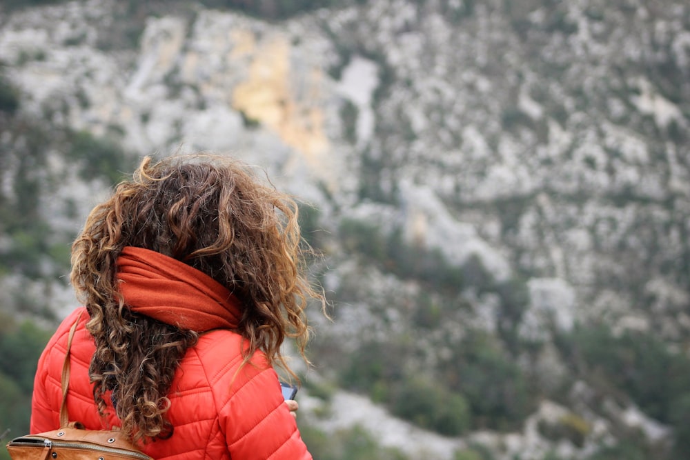 woman wearing bubble jacket near mountains