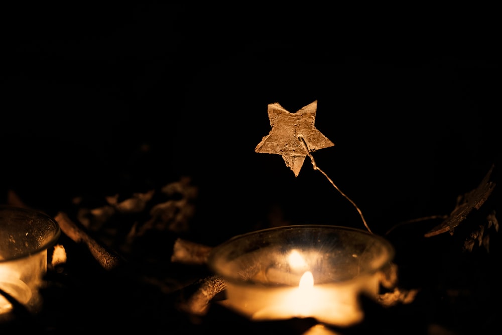 lit candle near star decor