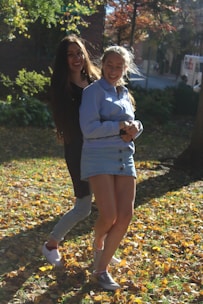 A smiling couple sharing a gentle embrace in a sunlit park.