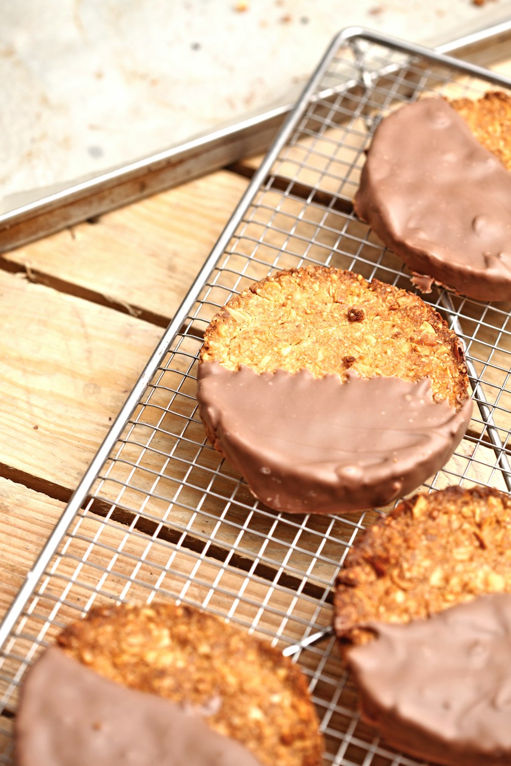 cookies with chocolate syrup on mesh metal tray