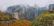Man admiring the painted monasteries of Bukovina surrounded by autumn colors.